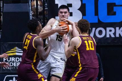 Dec 4, 2022; West Lafayette, Indiana, USA; Purdue Boilermakers center Zach Edey (15) rebounds the ball while Minnesota Golden Gophers forward Jamison Battle (10) and  guard Jackson Purcell (11) defend in the first half at Mackey Arena. Mandatory Credit: Trevor Ruszkowski-USA TODAY Sports