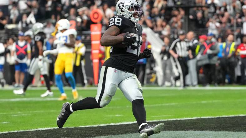 Dec 4, 2022; Paradise, Nevada, USA; Las Vegas Raiders running back Josh Jacobs (28) scores a touchdown against the Los Angeles Chargers during the first half at Allegiant Stadium. Mandatory Credit: Stephen R. Sylvanie-USA TODAY Sports