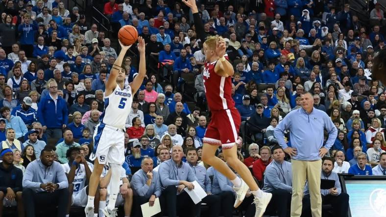 Dec 4, 2022; Omaha, Nebraska, USA;  Creighton Bluejays guard Francisco Farabello (5) scores on a three point shot over Nebraska Cornhuskers guard Sam Griesel (5) in the second half at CHI Health Center Omaha. Mandatory Credit: Steven Branscombe-USA TODAY Sports