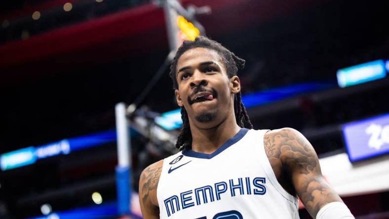 Dec 4, 2022; Detroit, Michigan, USA; Memphis Grizzlies guard Ja Morant (12) looks at the crowd after making a basket in the second half against the Detroit Pistons at Little Caesars Arena. Mandatory Credit: Allison Farrand-USA TODAY Sports