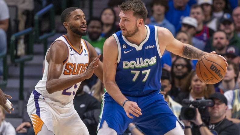 Dec 5, 2022; Dallas, Texas, USA; Phoenix Suns forward Mikal Bridges (25) guards Dallas Mavericks guard Luka Doncic (77) during the first quarter at the American Airlines Center. Mandatory Credit: Jerome Miron-USA TODAY Sports