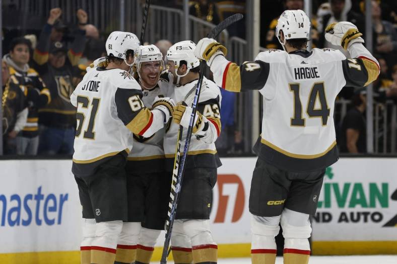 Dec 5, 2022; Boston, Massachusetts, USA; Vegas Golden Knights right wing Reilly Smith (center) is congratulated after his game winning goal during a shootout against the Boston Bruins at TD Garden. Mandatory Credit: Winslow Townson-USA TODAY Sports