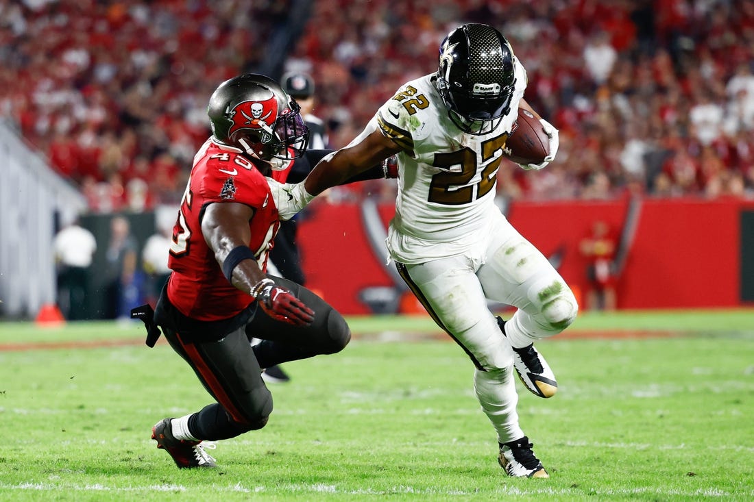 Dec 5, 2022; Tampa, Florida, USA; New Orleans Saints running back Mark Ingram II (22) runs with the ball as Tampa Bay Buccaneers linebacker Devin White (45) defends during the fourth quarter at Raymond James Stadium. Mandatory Credit: Douglas DeFelice-USA TODAY Sports