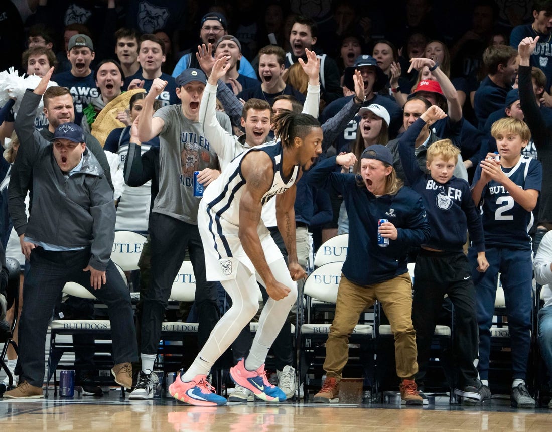 Butler Bulldogs fans elate with Butler Bulldogs center Manny Bates (15) after throwing down a dunk Monday, Nov. 7, 2022, at Hinkle Fieldhouse in Indianapolis. The sellout crowd was raucous for the entirety of the Bulldog's first game of the season.

Butler 11072022 Af037