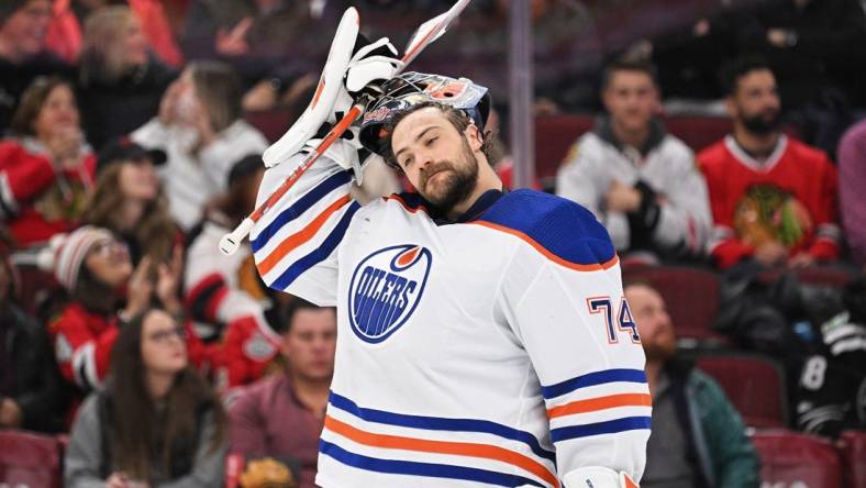 Nov 30, 2022; Chicago, Illinois, USA;  Edmonton Oilers goaltender Stuart Skinner (74) takes a breather against the Chicago Blackhawks at United Center. Mandatory Credit: Jamie Sabau-USA TODAY Sports