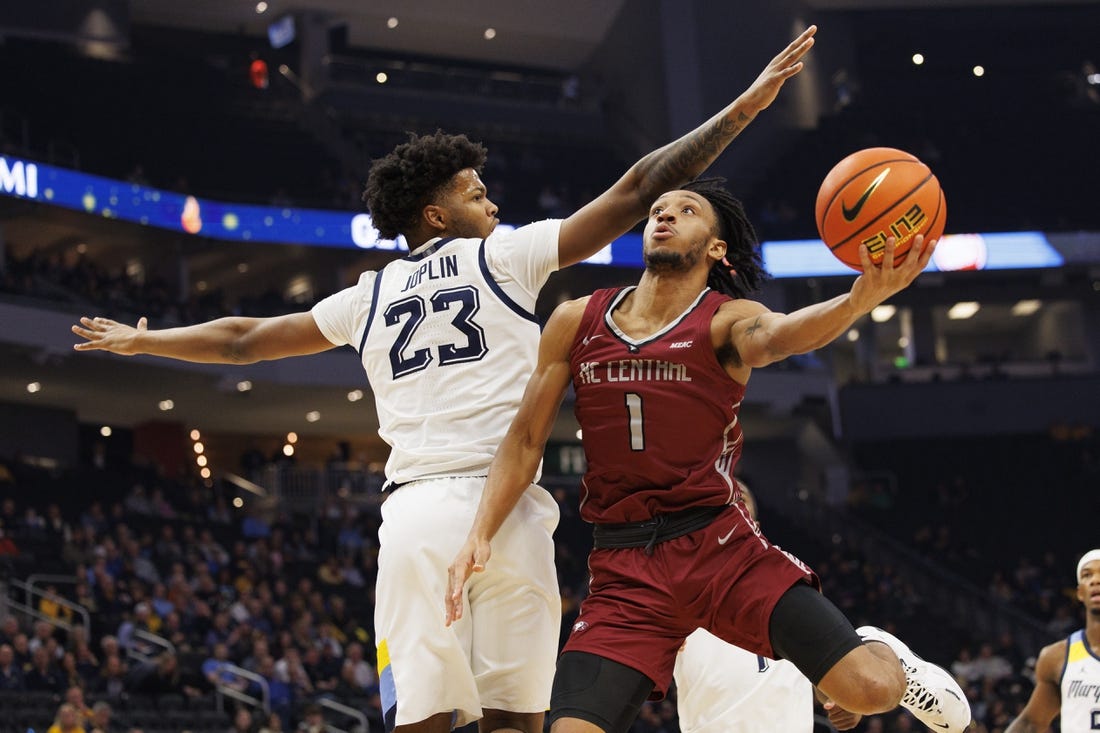 Dec 6, 2022; Milwaukee, Wisconsin, USA;  North Carolina Central Eagles guard Ja'darius Harris (1) shoots around Marquette Golden Eagles forward David Joplin (23) during the first half at Fiserv Forum. Mandatory Credit: Jeff Hanisch-USA TODAY Sports