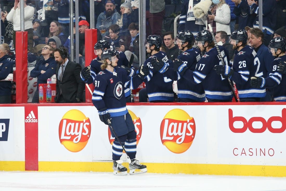 Dec 6, 2022; Winnipeg, Manitoba, CAN;  Winnipeg Jets forward Kyle Connor (81) is congratulated by his teammates on his goal against the Florida Panthers during the first period at Canada Life Centre. Mandatory Credit: Terrence Lee-USA TODAY Sports