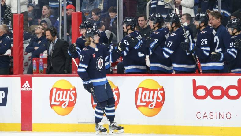 Dec 6, 2022; Winnipeg, Manitoba, CAN;  Winnipeg Jets forward Kyle Connor (81) is congratulated by his teammates on his goal against the Florida Panthers during the first period at Canada Life Centre. Mandatory Credit: Terrence Lee-USA TODAY Sports