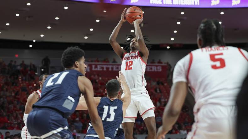 Dec 6, 2022; Houston, Texas, USA; Houston Cougars guard Tramon Mark (12) shoots the ball during the first half against the North Florida Ospreys at Fertitta Center. Mandatory Credit: Troy Taormina-USA TODAY Sports