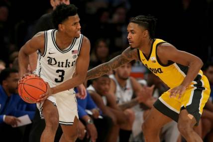 Dec 6, 2022; New York, New York, USA; Duke Blue Devils guard Jeremy Roach (3) controls the ball against Iowa Hawkeyes guard Ahron Ulis (1) during the second half at Madison Square Garden. Mandatory Credit: Brad Penner-USA TODAY Sports