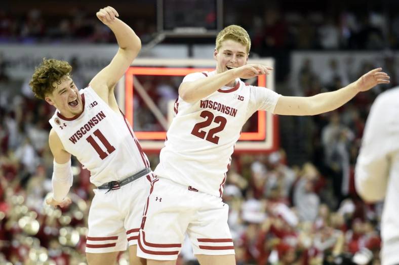 Dec 6, 2022; Madison, Wisconsin, USA;  Wisconsin Badgers guard Max Klesmit (11) and forward Steven Crowl (22) celebrate their win over the Maryland Terrapins at the Kohl Center. Mandatory Credit: Kayla Wolf-USA TODAY Sports
