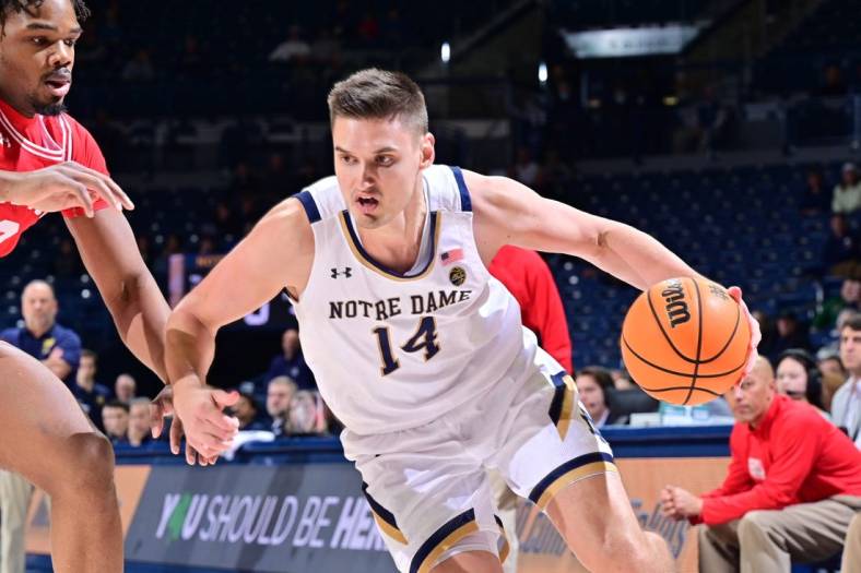 Dec 7, 2022; South Bend, Indiana, USA; Notre Dame Fighting Irish forward Nate Laszewski (14) drives to the basket as Boston University Terriers forward Malcolm Chimezie (3) defends in the first half at the Purcell Pavilion. Mandatory Credit: Matt Cashore-USA TODAY Sports