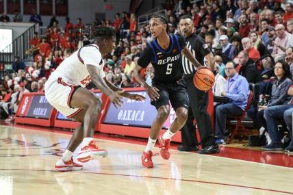 Dec 7, 2022; Queens, New York, USA; DePaul Blue Demons guard Philmon Gebrewhit (5) drives past St. John's Red Storm forward David Jones (23) in the first half at Carnesecca Arena. Mandatory Credit: Wendell Cruz-USA TODAY Sports