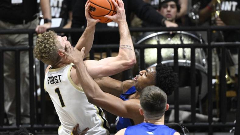 Dec 7, 2022; West Lafayette, Indiana, USA; Hofstra Pride forward Warren Williams (0) gets his hand on the face of Purdue Boilermakers forward Caleb Furst (1) during the first half at Mackey Arena. Mandatory Credit: Marc Lebryk-USA TODAY Sports