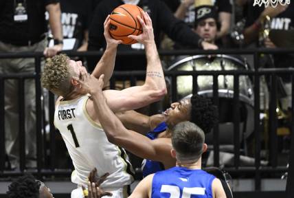Dec 7, 2022; West Lafayette, Indiana, USA; Hofstra Pride forward Warren Williams (0) gets his hand on the face of Purdue Boilermakers forward Caleb Furst (1) during the first half at Mackey Arena. Mandatory Credit: Marc Lebryk-USA TODAY Sports