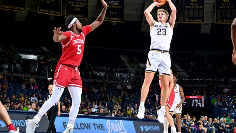 Dec 7, 2022; South Bend, Indiana, USA; Notre Dame Fighting Irish guard Dane Goodwin (23) shoots over Boston University Terriers guard Walter Whyte (5) in the first half at the Purcell Pavilion. Mandatory Credit: Matt Cashore-USA TODAY Sports