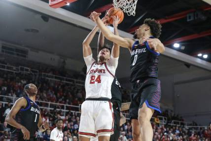 Dec 7, 2022; Queens, New York, USA; St. John's Red Storm guard Rafael Pinzon (24) shoots over DePaul Blue Demons guard Zion Cruz (0) in the second half at Carnesecca Arena. Mandatory Credit: Wendell Cruz-USA TODAY Sports
