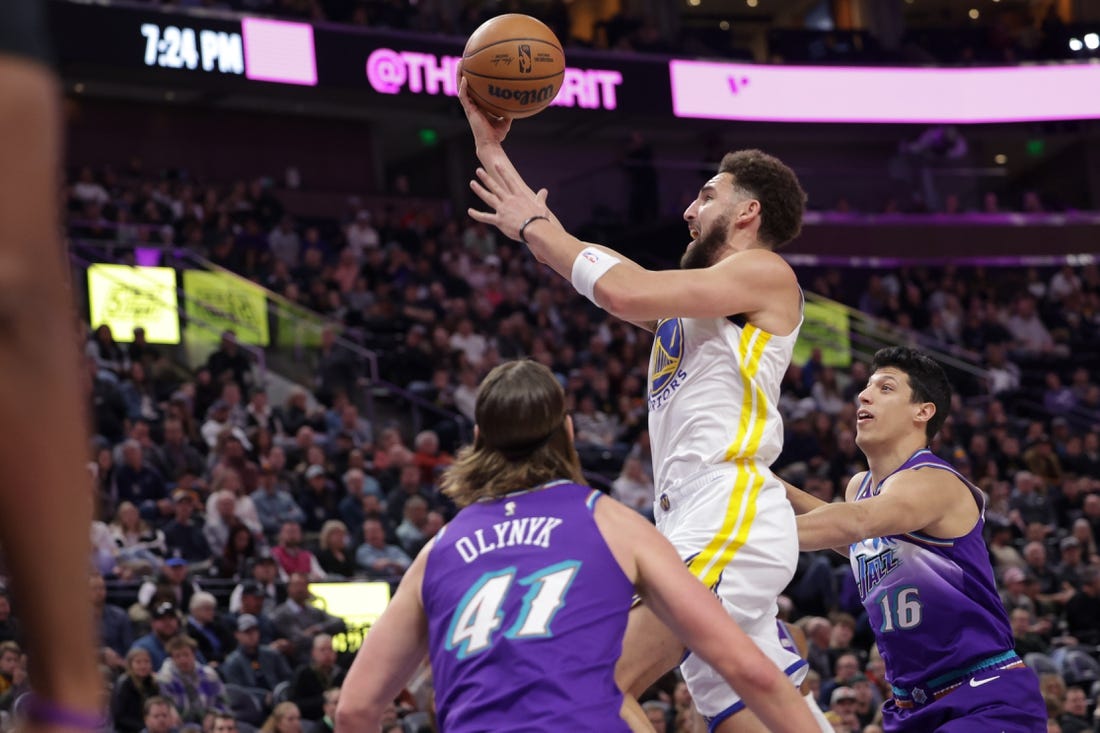 Dec 7, 2022; Salt Lake City, Utah, USA; Golden State Warriors guard Klay Thompson (11) attempts a shot during the first quarter against the Utah Jazz at Vivint Arena. Mandatory Credit: Chris Nicoll-USA TODAY Sports