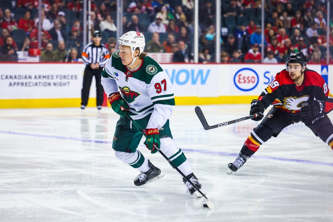 Dec 7, 2022; Calgary, Alberta, CAN; Minnesota Wild left wing Kirill Kaprizov (97) controls the puck against the Calgary Flames during the third period at Scotiabank Saddledome. Mandatory Credit: Sergei Belski-USA TODAY Sports