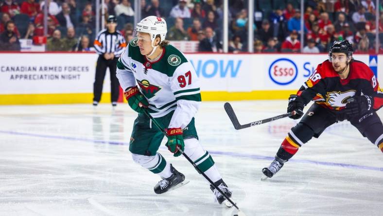 Dec 7, 2022; Calgary, Alberta, CAN; Minnesota Wild left wing Kirill Kaprizov (97) controls the puck against the Calgary Flames during the third period at Scotiabank Saddledome. Mandatory Credit: Sergei Belski-USA TODAY Sports