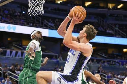Dec 5, 2022; Orlando, Florida, USA; Orlando Magic forward Franz Wagner (22) is fouled by Milwaukee Bucks forward Bobby Portis (9) during the first quarter at Amway Center. Mandatory Credit: Mike Watters-USA TODAY Sports