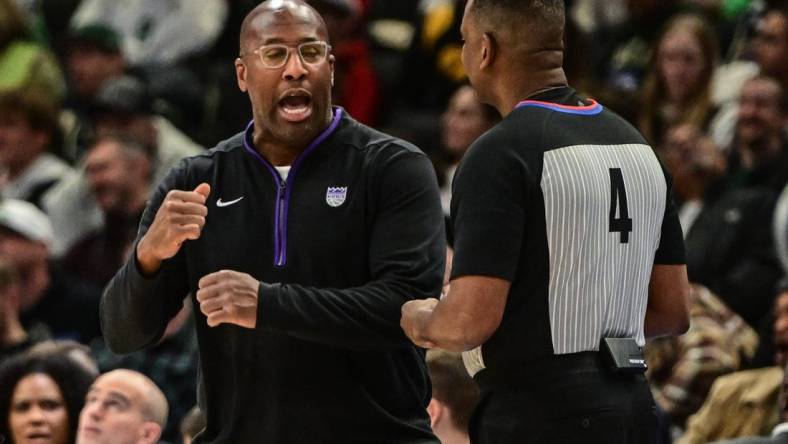 Dec 7, 2022; Milwaukee, Wisconsin, USA;  Sacramento Kings head coach Mike Brown talks to referee Sean Wright in the third quarter at Fiserv Forum. Mandatory Credit: Benny Sieu-USA TODAY Sports