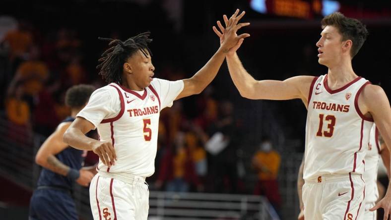 Dec 7, 2022; Los Angeles, California, USA; Southern California Trojans guard Boogie Ellis (5) and guard Drew Peterson (13) celebrate against the Cal State Fullerton Titans in the first half at Galen Center. Mandatory Credit: Kirby Lee-USA TODAY Sports