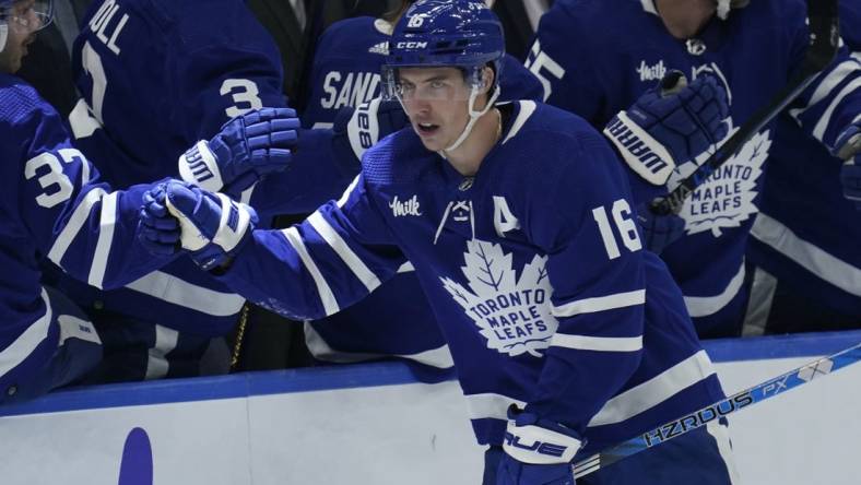 Dec 8, 2022; Toronto, Ontario, CAN; Toronto Maple Leafs forward Mitchell Marner (16) gets congratulated after scoring against the Los Angeles Kings during the second period at Scotiabank Arena. Mandatory Credit: John E. Sokolowski-USA TODAY Sports