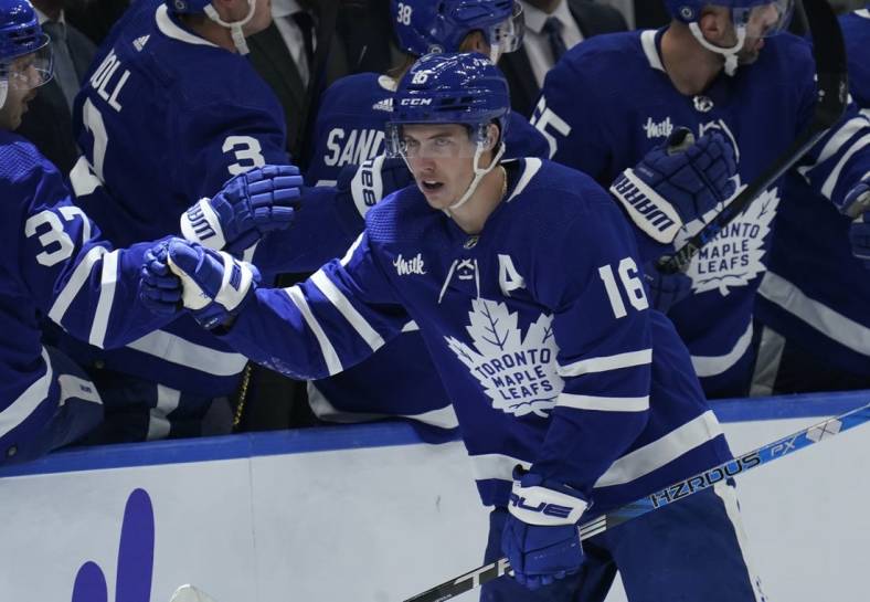 Dec 8, 2022; Toronto, Ontario, CAN; Toronto Maple Leafs forward Mitchell Marner (16) gets congratulated after scoring against the Los Angeles Kings during the second period at Scotiabank Arena. Mandatory Credit: John E. Sokolowski-USA TODAY Sports