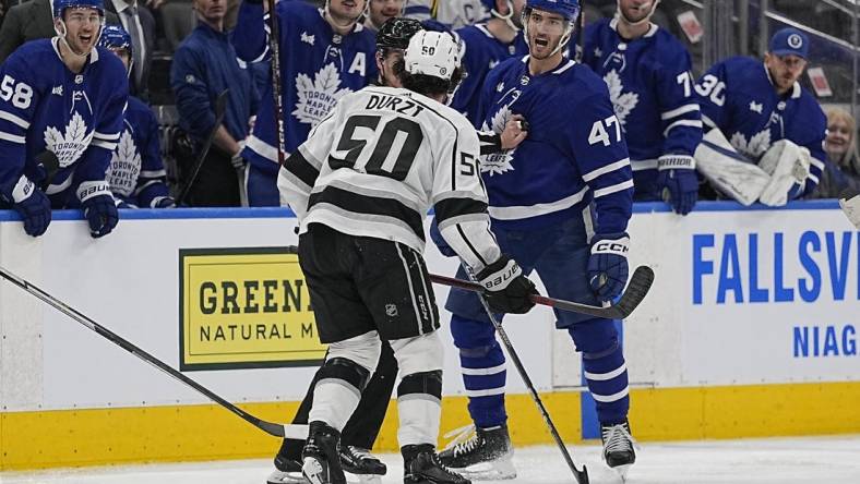 Dec 8, 2022; Toronto, Ontario, CAN; Toronto Maple Leafs forward Pierre Engvall (47) and Los Angeles Kings defenseman Sean Durzi (50) exchange words after a hit during the third period at Scotiabank Arena. Mandatory Credit: John E. Sokolowski-USA TODAY Sports