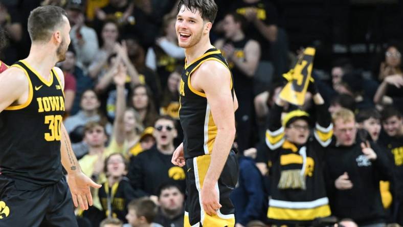 Dec 8, 2022; Iowa City, Iowa, USA; Iowa Hawkeyes forward Filip Rebraca (0) reacts with guard Connor McCaffery (30) during the second half against the Iowa State Cyclones at Carver-Hawkeye Arena. Mandatory Credit: Jeffrey Becker-USA TODAY Sports