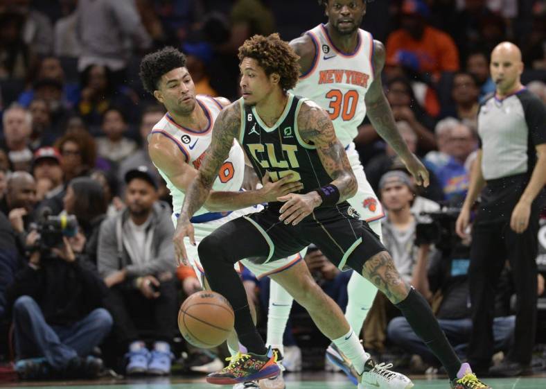 Dec 9, 2022; Charlotte, North Carolina, USA; Charlotte Hornets forward Kelly Oubre Jr. (12) drives past New York Knicks guard Quentin Grimes (6) during the first half at the Spectrum Center. Mandatory Credit: Sam Sharpe-USA TODAY Sports