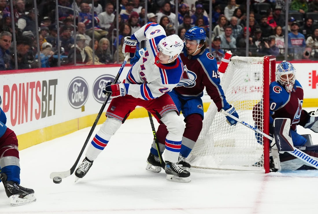 Dec 9, 2022; Denver, Colorado, USA; New York Rangers right wing Kaapo Kakko (24) controls the puck away from Colorado Avalanche defenseman Samuel Girard (49) in the first period at Ball Arena. Mandatory Credit: Ron Chenoy-USA TODAY Sports