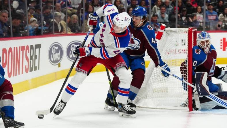 Dec 9, 2022; Denver, Colorado, USA; New York Rangers right wing Kaapo Kakko (24) controls the puck away from Colorado Avalanche defenseman Samuel Girard (49) in the first period at Ball Arena. Mandatory Credit: Ron Chenoy-USA TODAY Sports