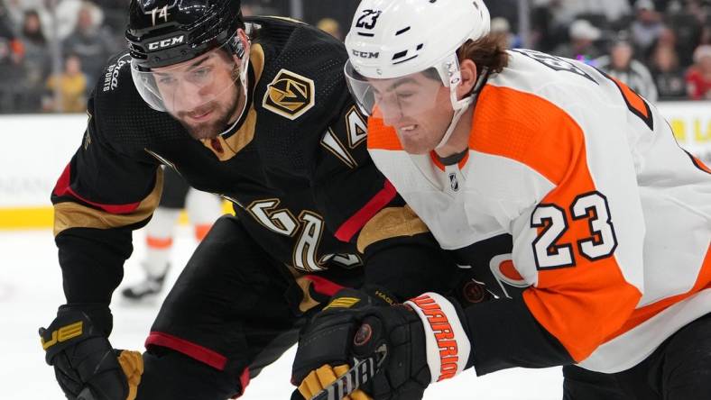 Dec 9, 2022; Las Vegas, Nevada, USA; Vegas Golden Knights defenseman Nicolas Hague (14) skates against Philadelphia Flyers center Lukas Sedlak (23) during the first period at T-Mobile Arena. Mandatory Credit: Stephen R. Sylvanie-USA TODAY Sports