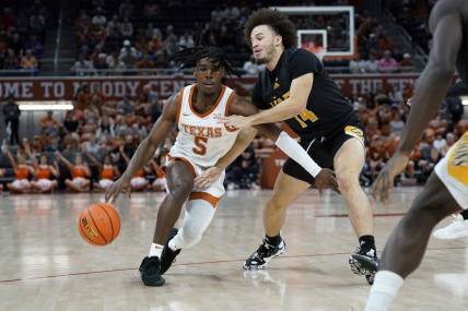 Dec 10, 2022; Austin, Texas, USA; Texas Longhorns guard Marcus Carr (5) drives to the basket Arkansas Pine-Bluff Golden Lions guard Brahm Harris (14) during the first half at Moody Center. Mandatory Credit: Scott Wachter-USA TODAY Sports