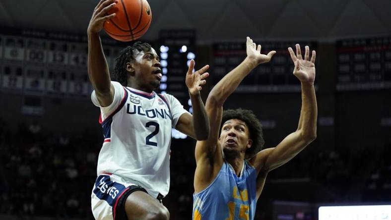 Dec 10, 2022; Storrs, Connecticut, USA; UConn Huskies guard Tristen Newton (2) shoots against Long Island Sharks forward/center C.J. Delancy (15) in the first half at Harry A. Gampel Pavilion. Mandatory Credit: David Butler II-USA TODAY Sports