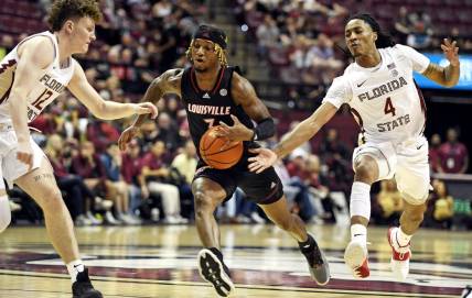 Dec 10, 2022; Tallahassee, Florida, USA; Louisville Cardinals El Ellis (3) has the ball tipped away by Florida State Seminoles guard Caleb Mills (4) during the first half at Donald L. Tucker Center. Mandatory Credit: Melina Myers-USA TODAY Sports