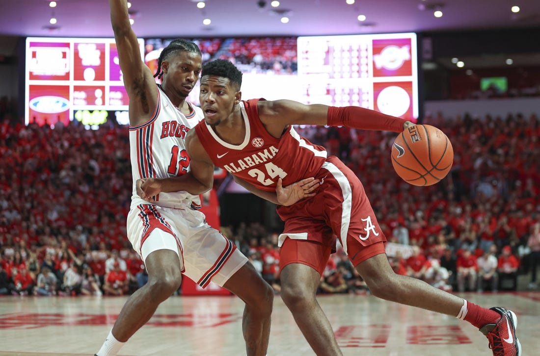 Dec 10, 2022; Houston, Texas, USA; Alabama Crimson Tide forward Brandon Miller (24) drives with the ball as Houston Cougars guard Tramon Mark (12) defends during the first half at Fertitta Center. Mandatory Credit: Troy Taormina-USA TODAY Sports
