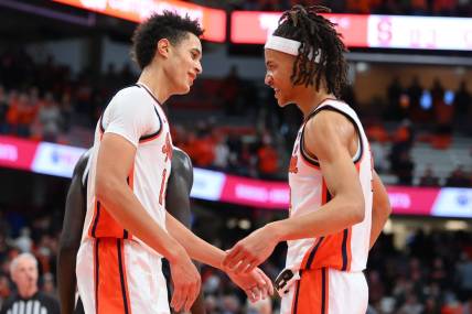 Dec 10, 2022; Syracuse, New York, USA; Syracuse Orange center Jesse Edwards (left) and forward Benny Williams (right) celebrate following the game against the Georgetown Hoyas at the JMA Wireless Dome. Mandatory Credit: Rich Barnes-USA TODAY Sports
