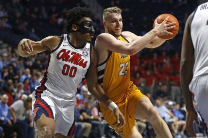 Dec 10, 2022; Oxford, Mississippi, USA; Valparaiso Beacons forward Ben Krikke (23) drives to the basket as Mississippi Rebels forward Jayveous McKinnis (0) defends during the first half at The Sandy and John Black Pavilion at Ole Miss. Mandatory Credit: Petre Thomas-USA TODAY Sports