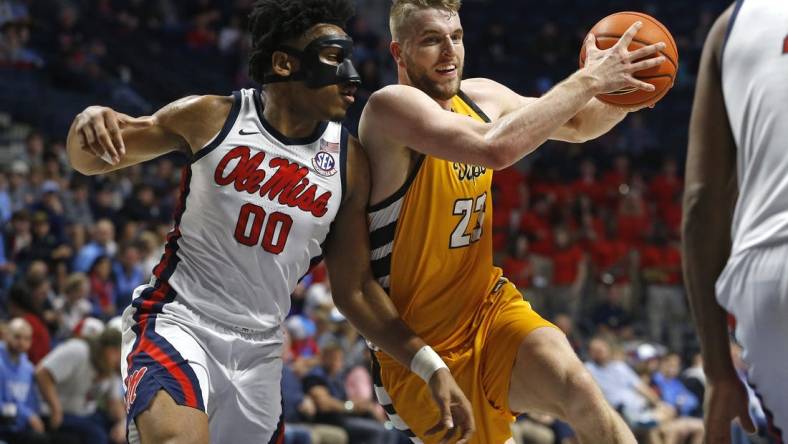 Dec 10, 2022; Oxford, Mississippi, USA; Valparaiso Beacons forward Ben Krikke (23) drives to the basket as Mississippi Rebels forward Jayveous McKinnis (0) defends during the first half at The Sandy and John Black Pavilion at Ole Miss. Mandatory Credit: Petre Thomas-USA TODAY Sports