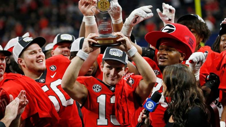 Georgia quarterback Stetson Bennett (13) raises the SEC Championship MVP trophy after the SEC Championship NCAA college football game between LSU and Georgia in Atlanta, on Saturday, Dec. 3, 2022. Georgia won 50-30.

News Joshua L Jones