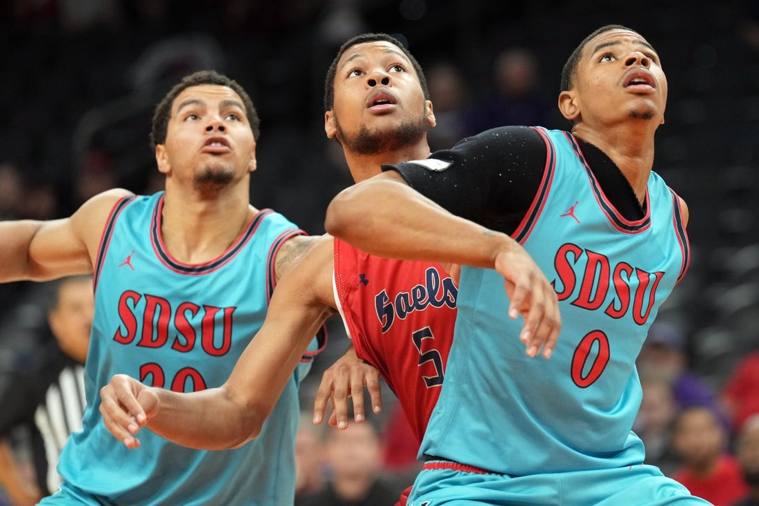 Dec 10, 2022; Phoenix, Arizona, USA; San Diego State Aztecs guard Matt Bradley (20) and San Diego State Aztecs forward Keshad Johnson (0) box out St. Mary's Gaels forward Josh Jefferson (5) during the first half at Footprint Center. Mandatory Credit: Joe Camporeale-USA TODAY Sports