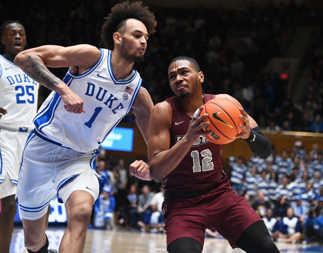 Dec 10, 2022; Durham, North Carolina, USA; Maryland Eastern Shore Eagles forward Nathaniel Pollard Jr. (12) drives to the basket as Duke Blue Devils center Dereck Lively (1) defends during the first half at Cameron Indoor Stadium. Mandatory Credit: Rob Kinnan-USA TODAY Sports