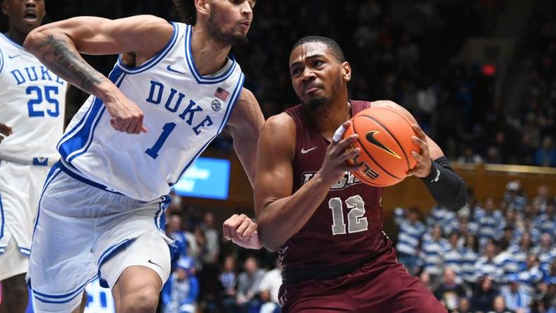 Dec 10, 2022; Durham, North Carolina, USA; Maryland Eastern Shore Eagles forward Nathaniel Pollard Jr. (12) drives to the basket as Duke Blue Devils center Dereck Lively (1) defends during the first half at Cameron Indoor Stadium. Mandatory Credit: Rob Kinnan-USA TODAY Sports