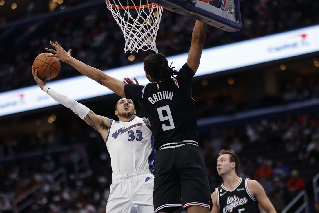 Dec 10, 2022; Washington, District of Columbia, USA; Washington Wizards forward Kyle Kuzma (33) shoots the ball as Los Angeles Clippers forward Moses Brown (9) defends in the second quarter at Capital One Arena. Mandatory Credit: Geoff Burke-USA TODAY Sports