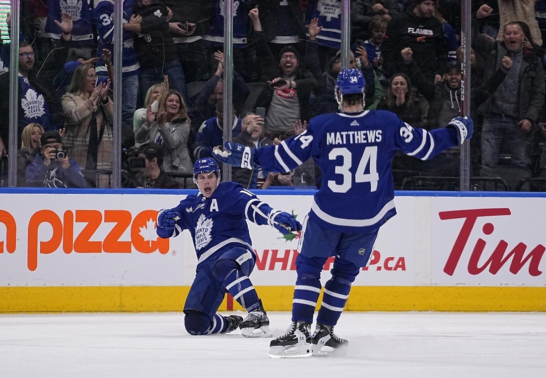 Dec 10, 2022; Toronto, Ontario, CAN; Toronto Maple Leafs forward Mitchell Marner (16) celebrates with forward Auston Matthews (34) after scoring the game winning goal against the Calgary Flames during overtime at Scotiabank Arena. Mandatory Credit: John E. Sokolowski-USA TODAY Sports