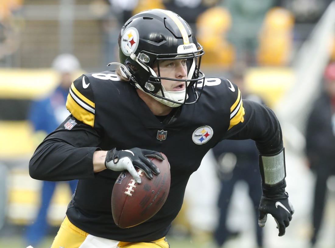 Dec 11, 2022; Pittsburgh, Pennsylvania, USA;  Pittsburgh Steelers quarterback Kenny Pickett (8) scrambles with the ball against the Baltimore Ravens during the first quarter at Acrisure Stadium. Mandatory Credit: Charles LeClaire-USA TODAY Sports