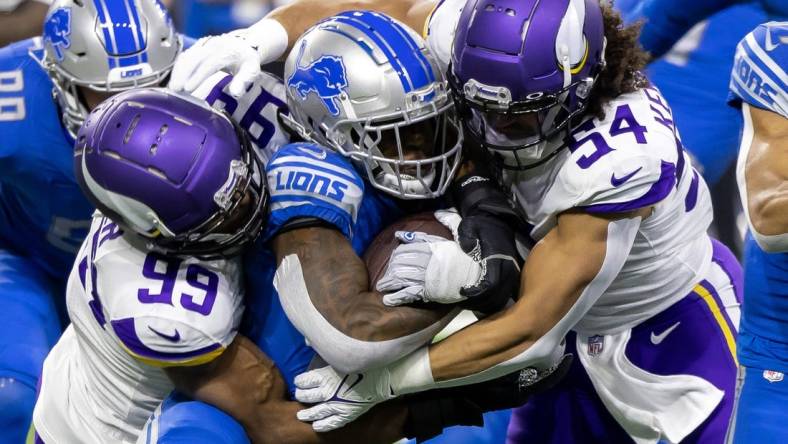 Dec 11, 2022; Detroit, Michigan, USA; Detroit Lions running back Jamaal Williams (30) is tackled by Minnesota Vikings linebacker Danielle Hunter (99) and linebacker Eric Kendricks (54) during the first quarter at Ford Field. Mandatory Credit: David Reginek-USA TODAY Sports